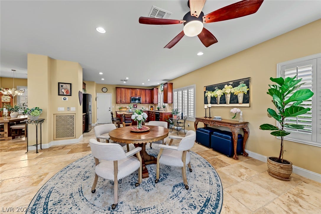 1646 Sebring Hills Drive, Henderson, NV 89052 Stone tile flooring and an open layout connect the casual dining area to the kitchen.