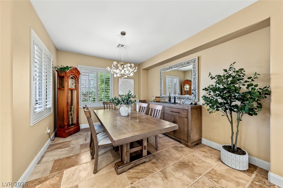 1646 Sebring Hills Drive, Henderson, NV 89052 Sunlight streams through plantation shutters onto classic stone flooring in this elegant dining room.