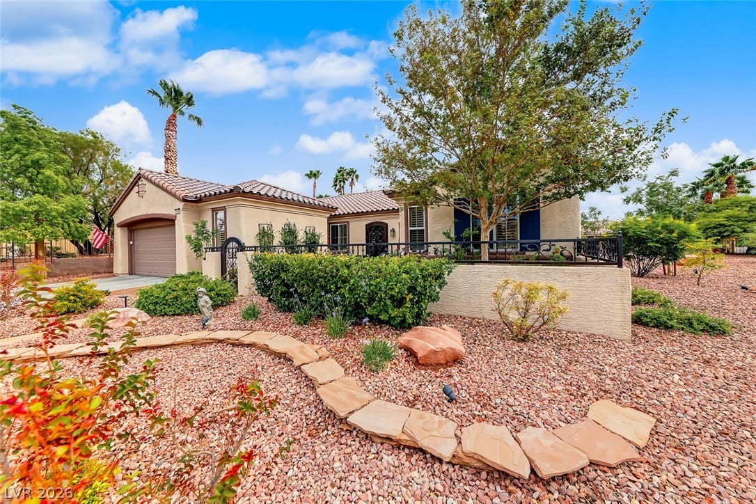 1646 Sebring Hills Drive, Henderson, NV 89052 Spanish tile roofing and classic stucco detailing define this elegant desert exterior.