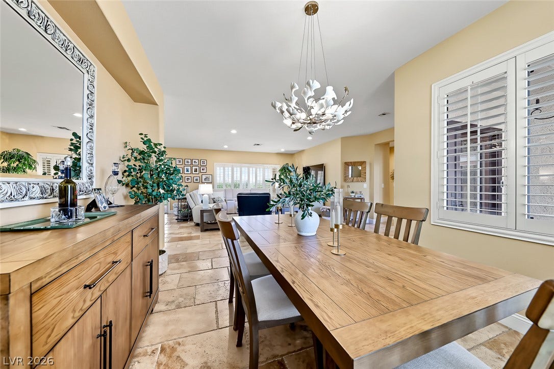 1646 Sebring Hills Drive, Henderson, NV 89052 A refined dining room displays warm travertine tile flooring and classic white plantation shutters.