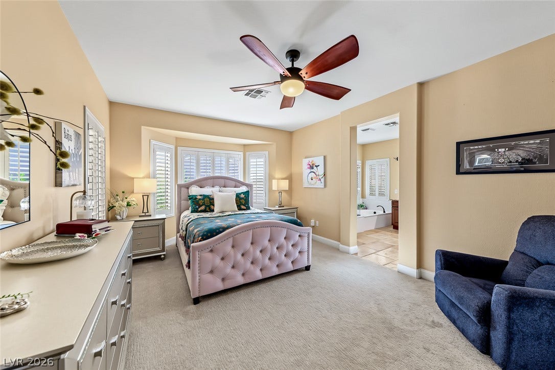 1646 Sebring Hills Drive, Henderson, NV 89052 A spacious bedroom featuring soft carpeting, window shutters, and direct access to an en-suite bath.