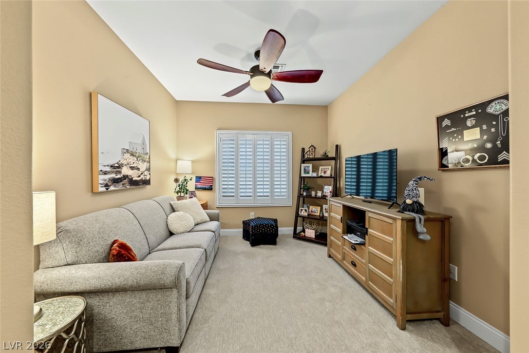 1646 Sebring Hills Drive, Henderson, NV 89052 Comfortable carpeted living spaces offer high ceilings and plantation shutters.