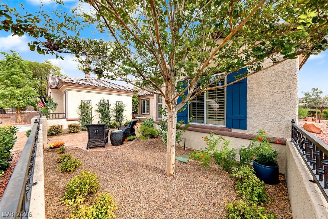 1646 Sebring Hills Drive, Henderson, NV 89052 Lush landscaping and stone pathways accent the stucco exterior of this charming residence.