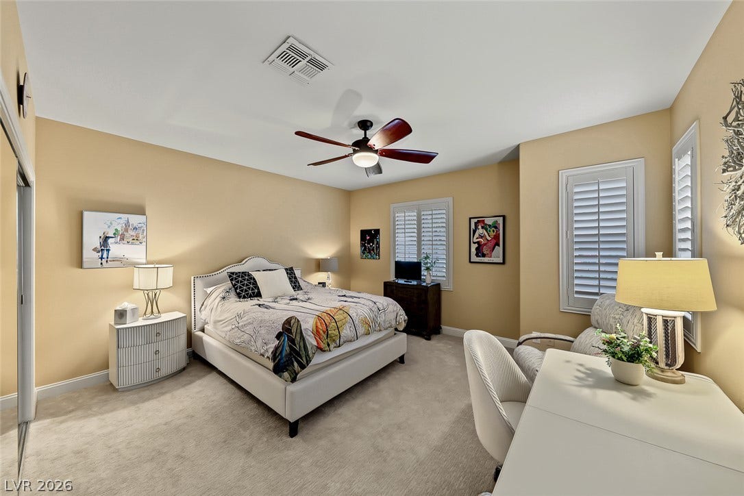1646 Sebring Hills Drive, Henderson, NV 89052 A spacious bedroom offers plush neutral carpeting and plantation shutters on the windows.