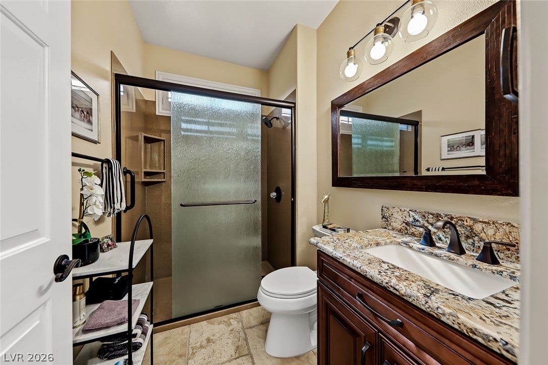 1646 Sebring Hills Drive, Henderson, NV 89052 Richly patterned stone countertops pair with textured tile flooring in this classic bathroom.
