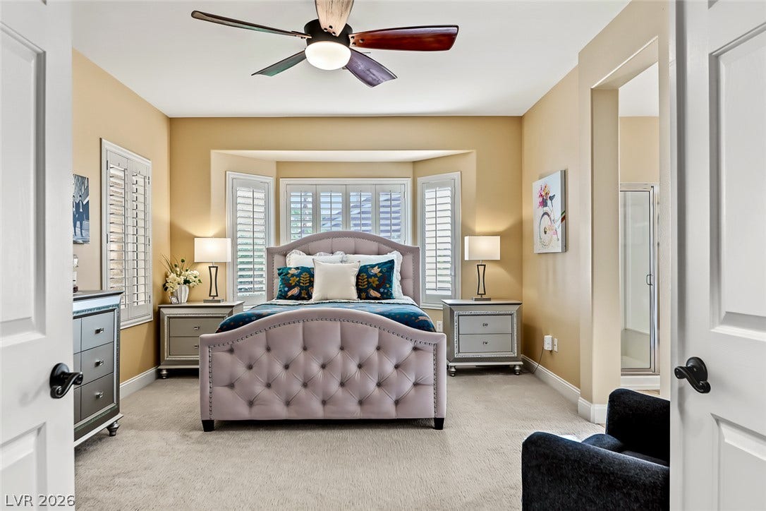 1646 Sebring Hills Drive, Henderson, NV 89052 An inviting bedroom features soft neutral carpeting, plantation shutters, and access to an ensuite bath.