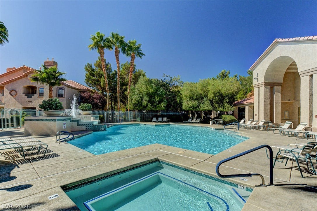 5415 W Harmon Avenue, #1029, Las Vegas, NV 89103 A sparkling community pool and spa are surrounded by mature palms and towering arched architecture.