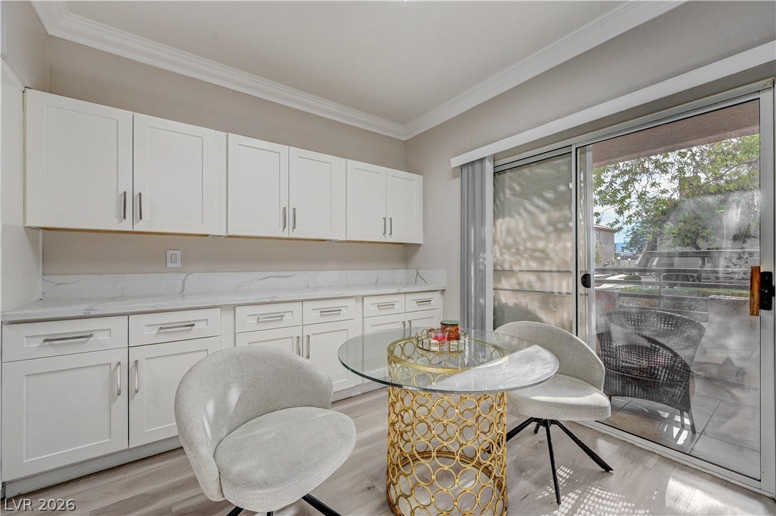 5415 W Harmon Avenue, #1029, Las Vegas, NV 89103 Elegant crown molding and glass sliding doors framing outdoor views define this functional space.