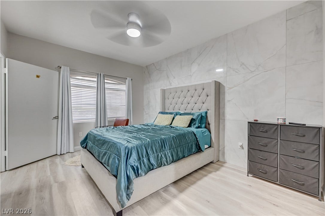 5415 W Harmon Avenue, #1029, Las Vegas, NV 89103 A polished accent wall and light-toned flooring define this restful bedroom space.