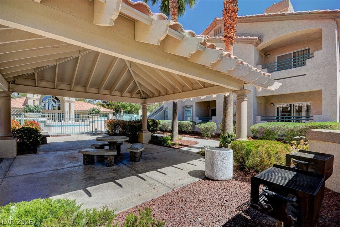 5415 W Harmon Avenue, #1029, Las Vegas, NV 89103 An inviting covered patio area offers sheltered seating next to community grills and manicured landscaping.