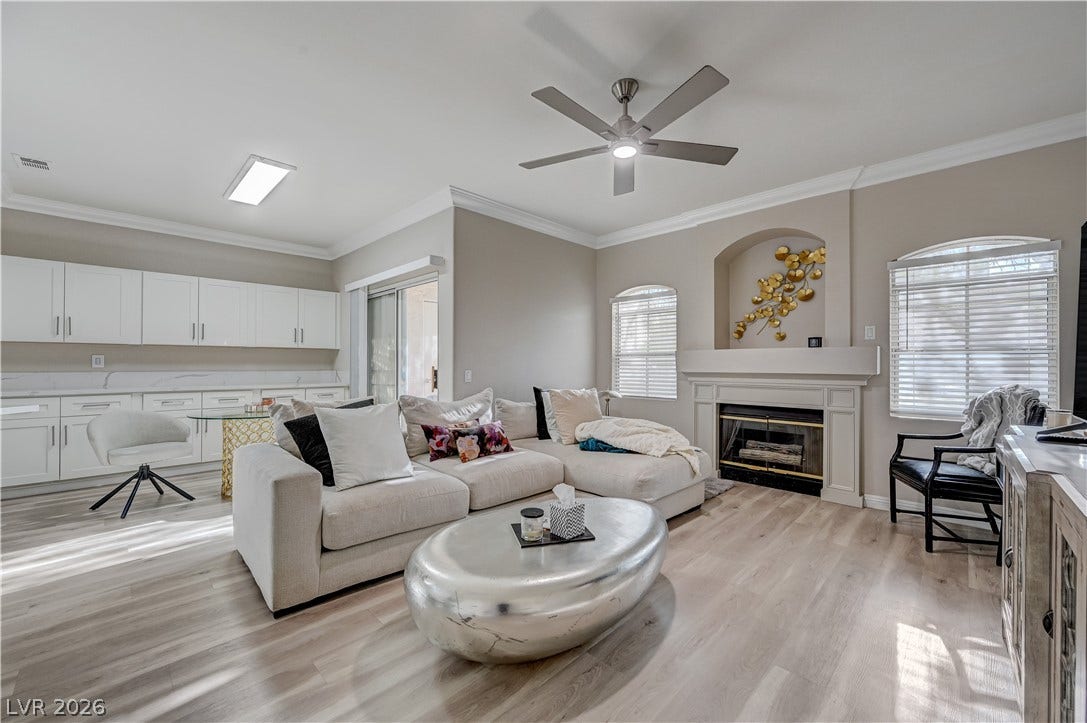 5415 W Harmon Avenue, #1029, Las Vegas, NV 89103 An inviting fireplace and wood-look flooring anchors this open living space.