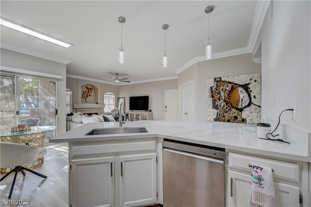 5415 W Harmon Avenue, #1029, Las Vegas, NV 89103 An open floor plan seamlessly connects the kitchen to the bright dining and living spaces.
