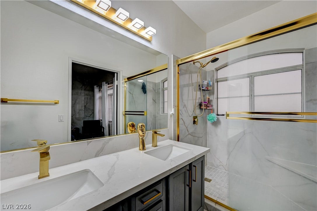 5415 W Harmon Avenue, #1029, Las Vegas, NV 89103 Lustrous gold hardware pairs with stone counters in this updated primary bathroom.