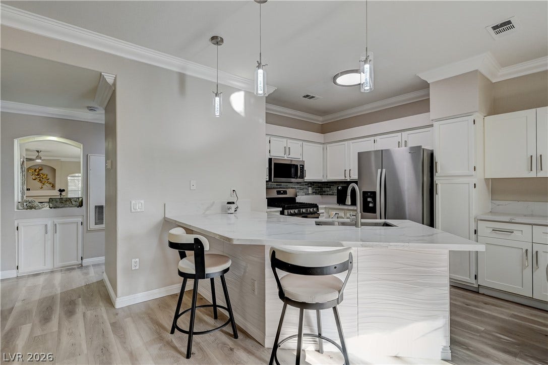 5415 W Harmon Avenue, #1029, Las Vegas, NV 89103 Clean lines and stone counters highlight this updated workspace with an adjacent breakfast bar.