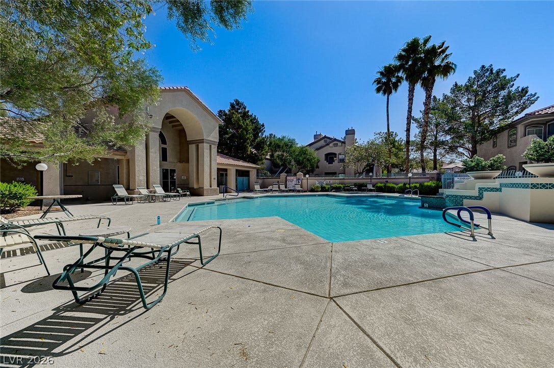 5415 W Harmon Avenue, #1029, Las Vegas, NV 89103 A sparkling community pool is framed by mature trees, palm views, and a spacious concrete patio.