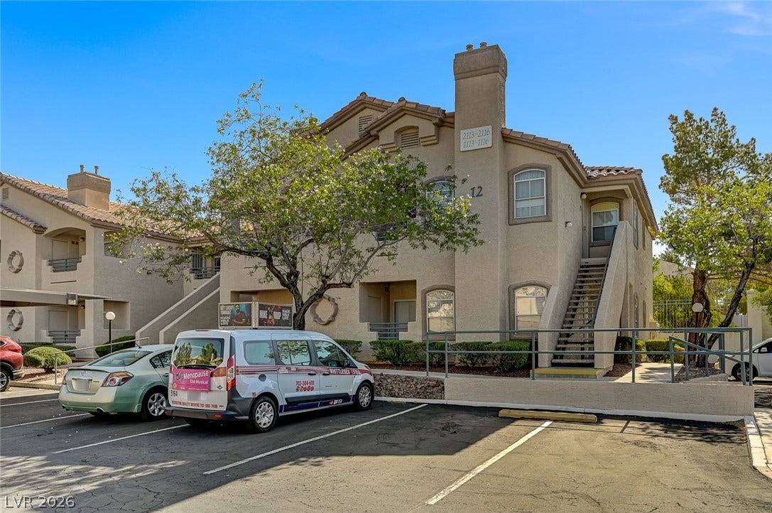 5415 W Harmon Avenue, #1029, Las Vegas, NV 89103 Stucco exterior elements and a classic tile roof define this multi-level residential building.
