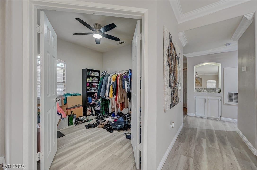 5415 W Harmon Avenue, #1029, Las Vegas, NV 89103 Double doors open to a spacious walk-in closet featuring modern wood-plank style flooring.