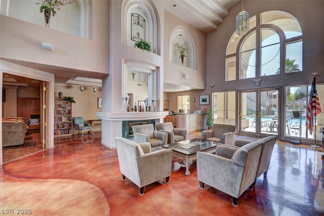 5415 W Harmon Avenue, #1029, Las Vegas, NV 89103 Polished concrete floors and soaring arched windows define this grand double-height lobby space.