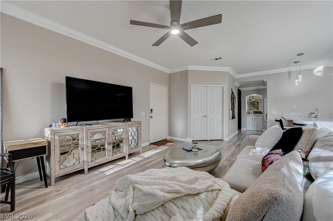 5415 W Harmon Avenue, #1029, Las Vegas, NV 89103 Elegant crown molding complements the sleek wood-look flooring throughout this open-concept living space.