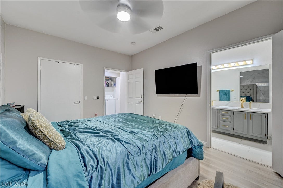 5415 W Harmon Avenue, #1029, Las Vegas, NV 89103 A comfortable bedroom includes access to a private bathroom and an adjacent laundry room.