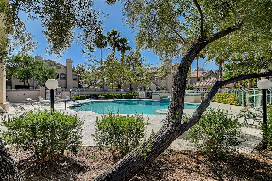 5415 W Harmon Avenue, #1029, Las Vegas, NV 89103 Mature trees frame a sparkling community swimming pool surrounded by a spacious concrete sundeck.