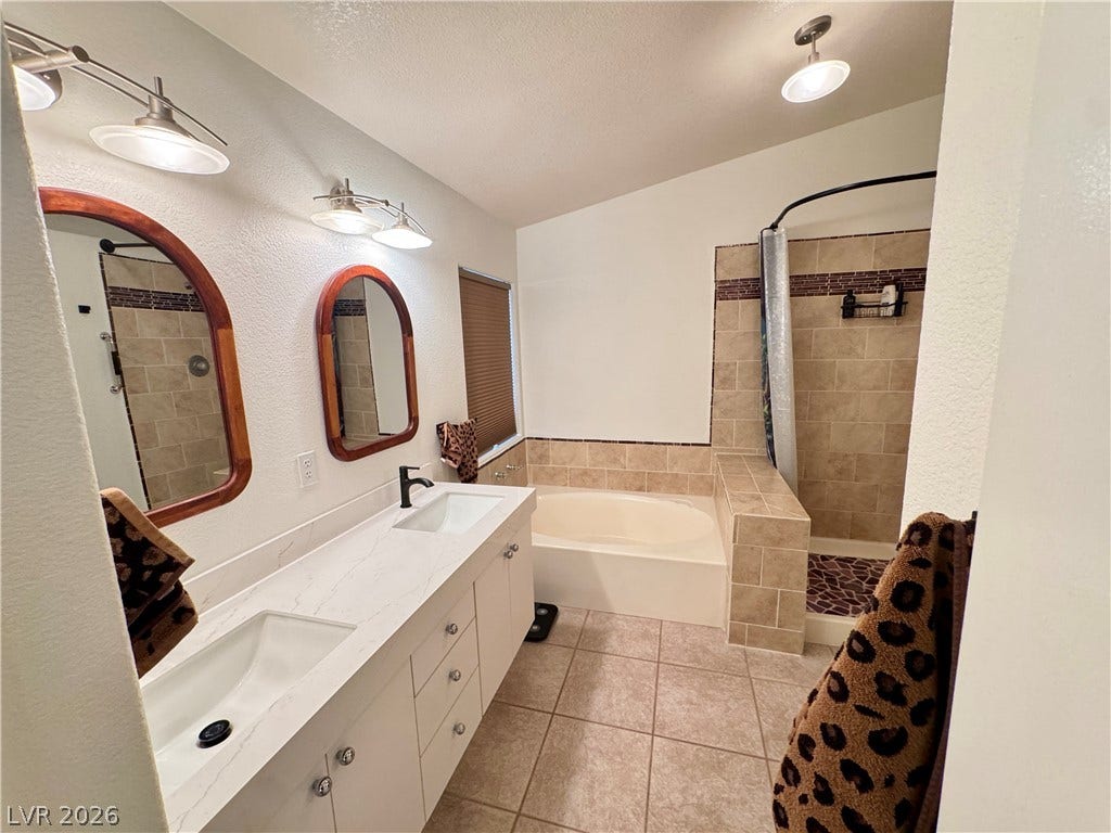 7652 Rolling View Drive, #202, Las Vegas, NV 89149 A spacious double vanity and a built-in soaking tub define this bathroom.