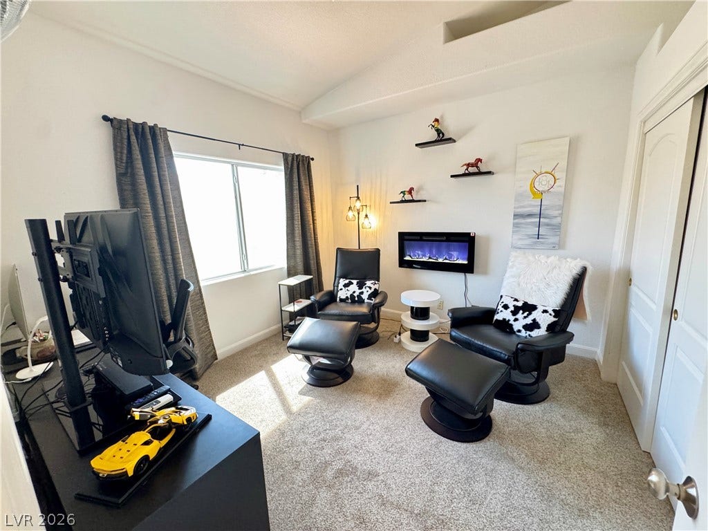 7652 Rolling View Drive, #202, Las Vegas, NV 89149 An inviting secondary bedroom showcases soft carpeting and high vaulted ceilings.