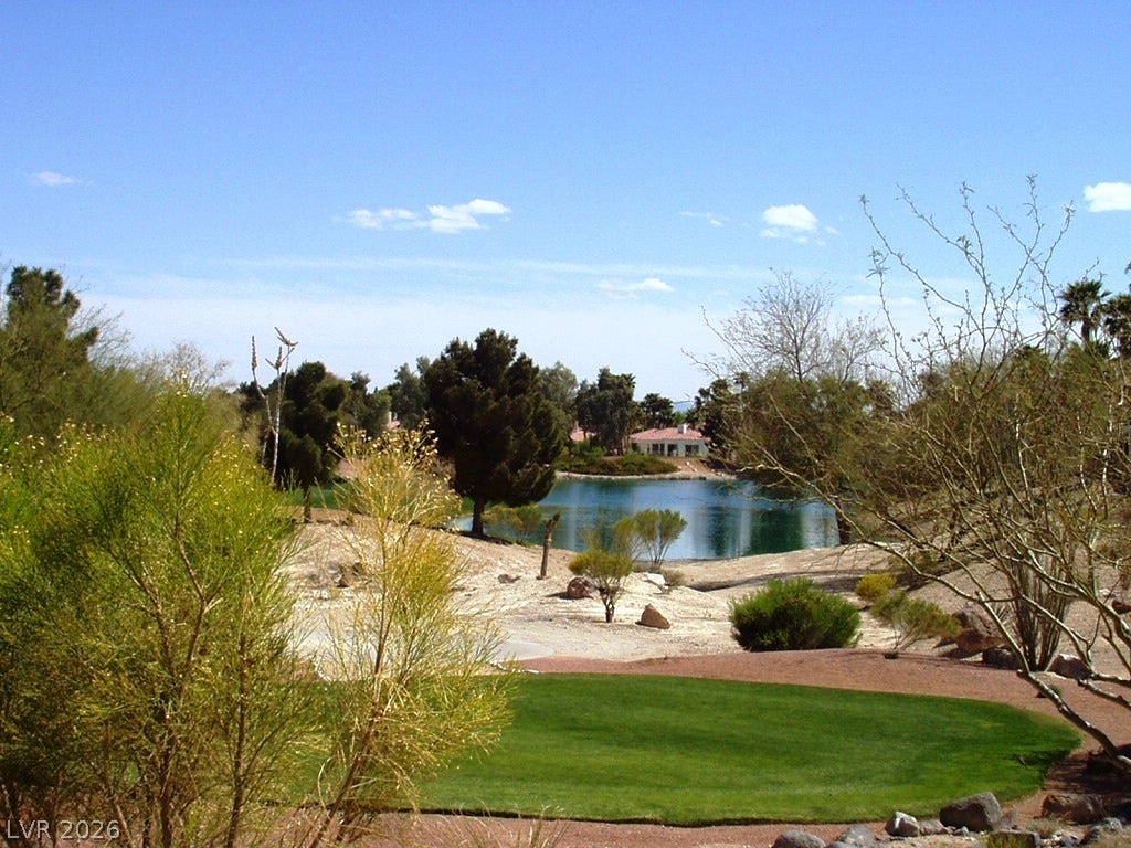 7652 Rolling View Drive, #202, Las Vegas, NV 89149 Lush fairways and a serene neighborhood lake create a scenic outdoor backdrop.