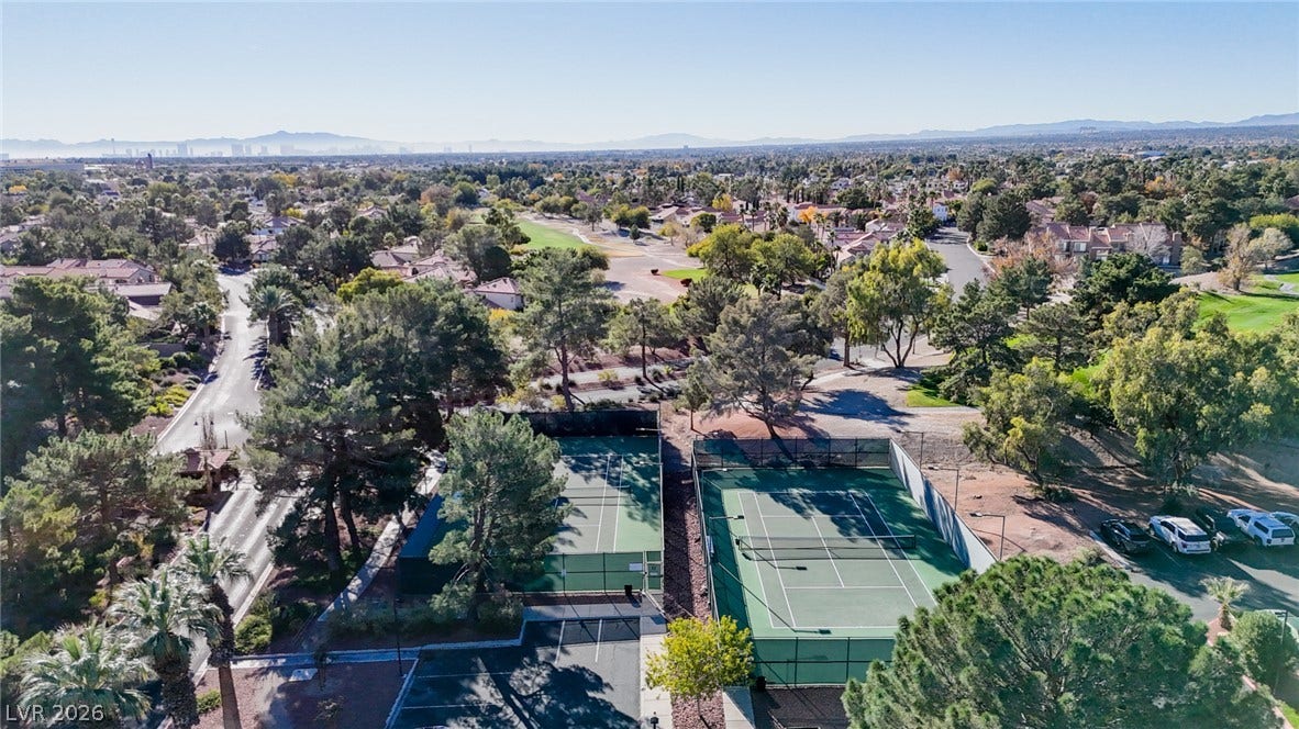 7652 Rolling View Drive, #202, Las Vegas, NV 89149 Mature trees frame the dual outdoor tennis courts overlooking a vast suburban landscape.