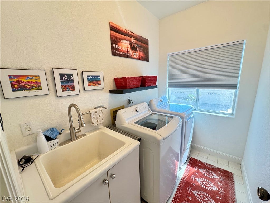 7652 Rolling View Drive, #202, Las Vegas, NV 89149 High ceilings and a deep utility sink elevate this functional laundry space.