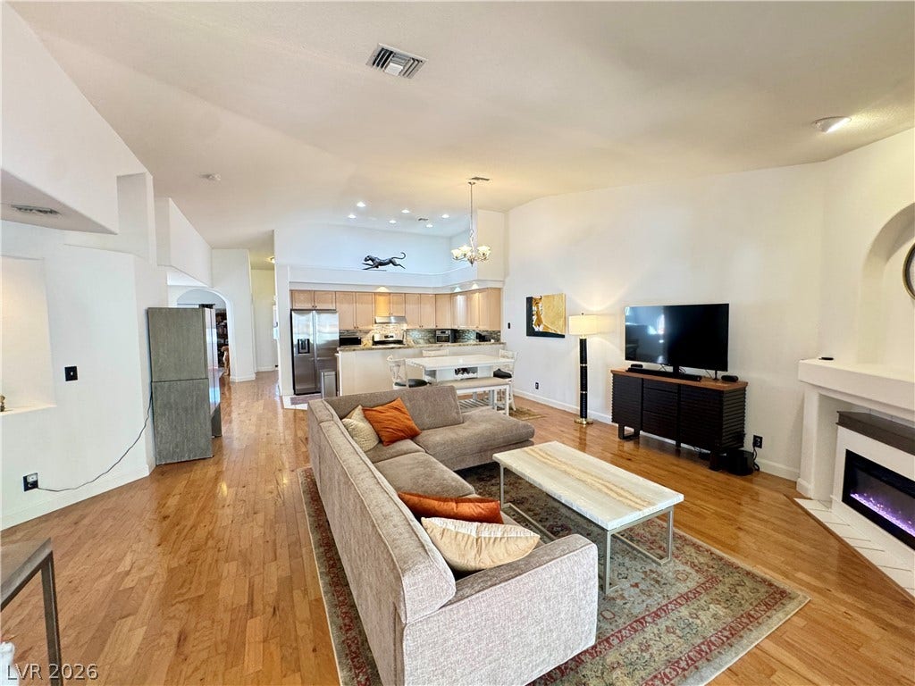 7652 Rolling View Drive, #202, Las Vegas, NV 89149 Polished wood floors and high ceilings frame this inviting open-concept living space.