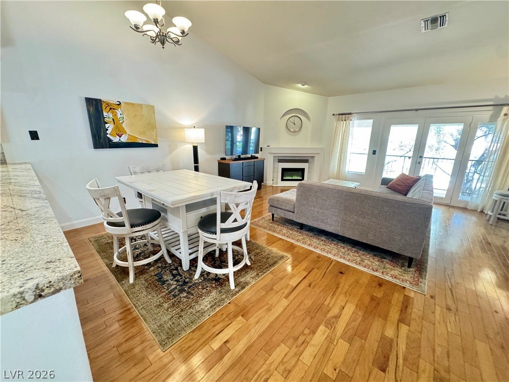 7652 Rolling View Drive, #202, Las Vegas, NV 89149 Polished hardwood flooring. Airy, open layout with a fireplace and vaulted ceiling.