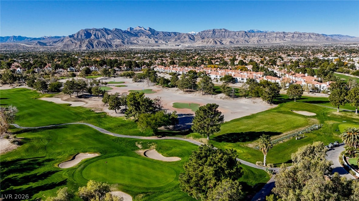 7652 Rolling View Drive, #202, Las Vegas, NV 89149 Dramatic mountain peaks frame this expansive green golf course winding through the neighborhood.
