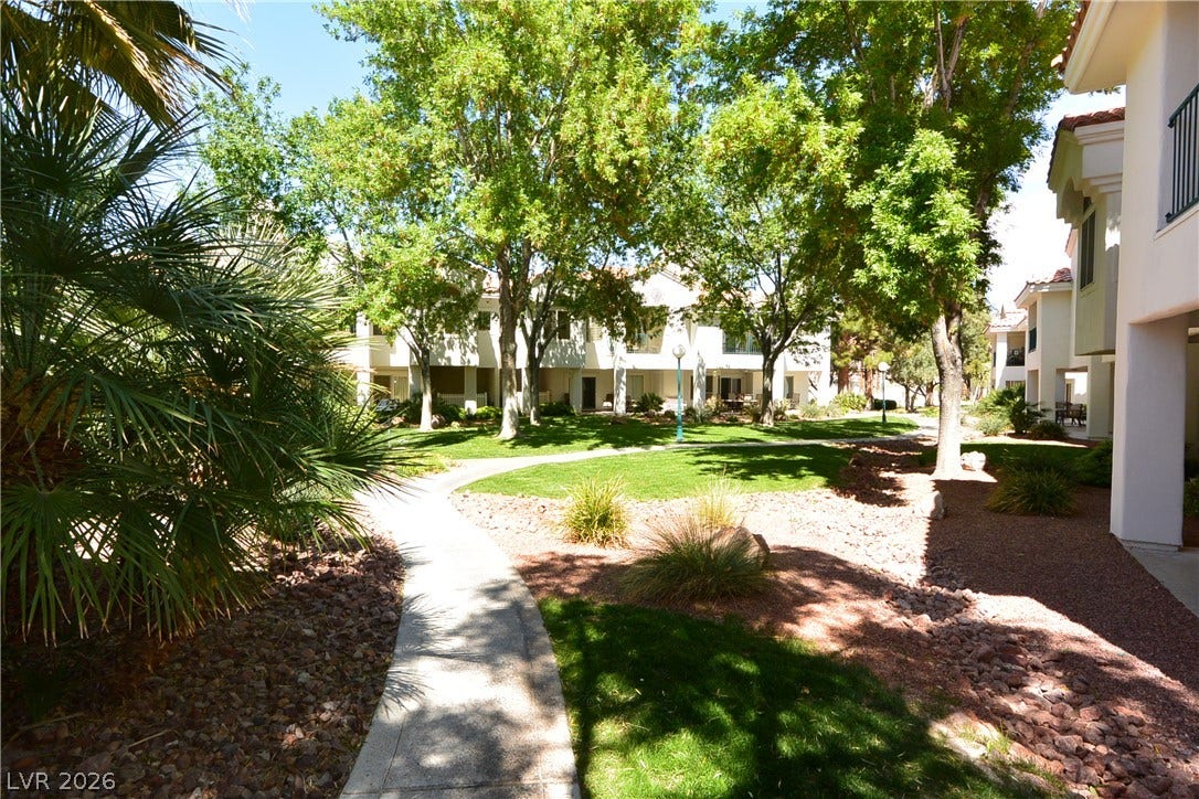 7652 Rolling View Drive, #202, Las Vegas, NV 89149 Mature trees shade a paved walkway winding through the beautifully landscaped green belt.