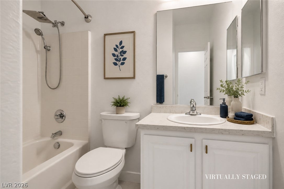 792 Valley Rise Drive, Henderson, NV 89052 A classic vanity with stone counters complements the neat tile surrounding the shower tub.