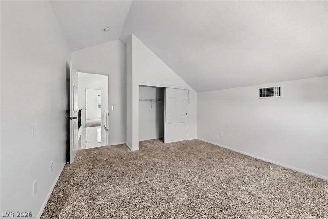 792 Valley Rise Drive, Henderson, NV 89052 Vaulted ceilings and plush carpeting define this versatile upper-level bedroom space.