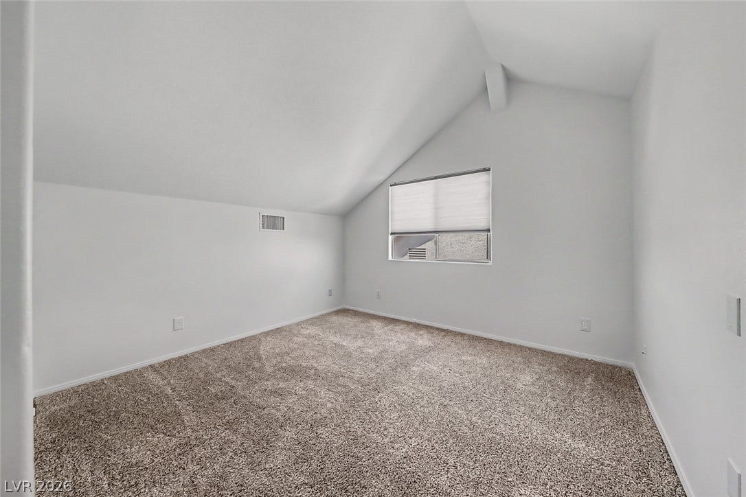 792 Valley Rise Drive, Henderson, NV 89052 Angled ceilings and soft carpeting create a cozy atmosphere in this upper-level room.