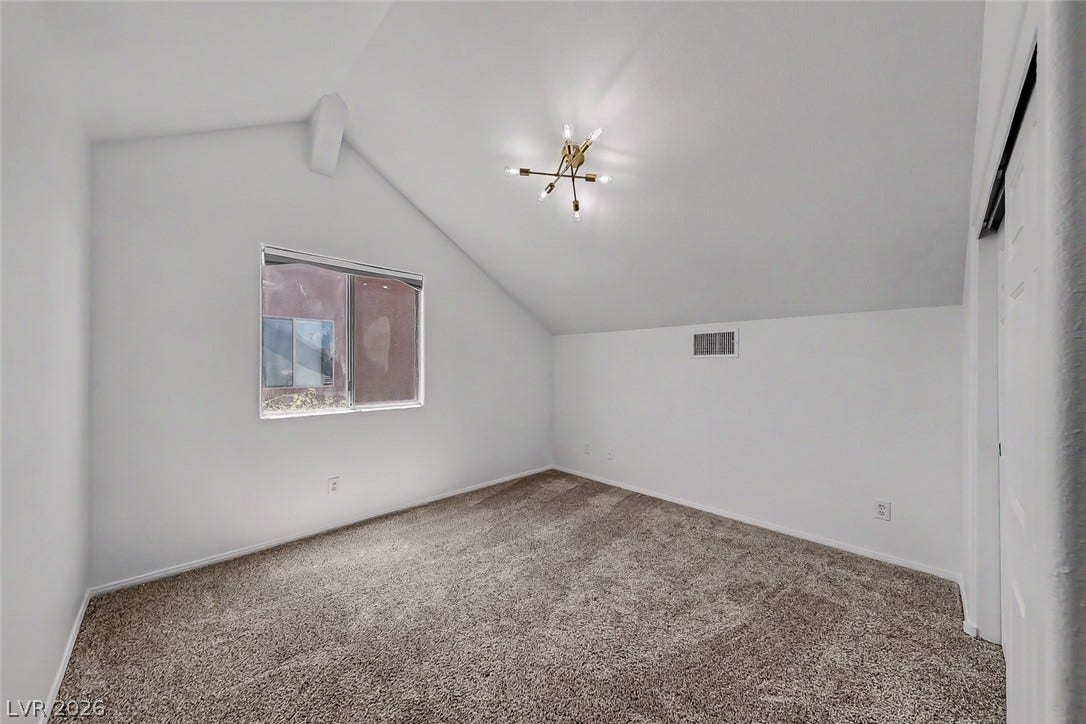 792 Valley Rise Drive, Henderson, NV 89052 Vaulted ceilings and plush carpeting define this quiet second-story bedroom space.