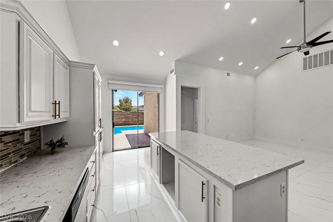 792 Valley Rise Drive, Henderson, NV 89052 Polished tile flooring flows from the sleek modern kitchen into an airy living area.