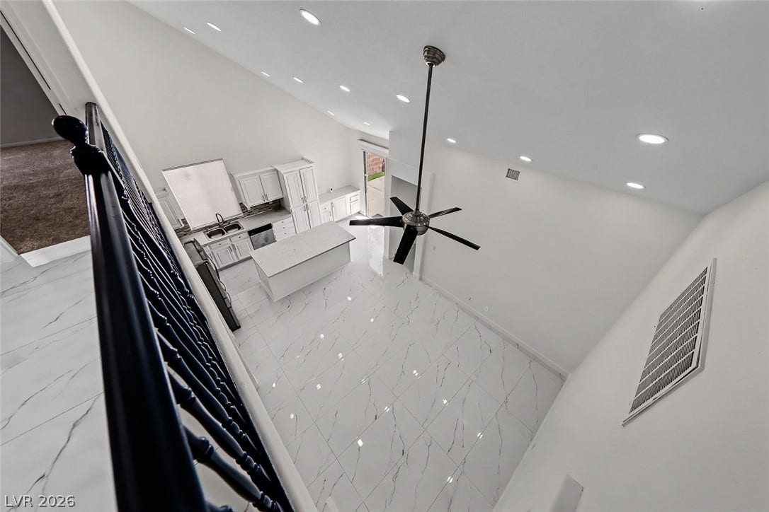 792 Valley Rise Drive, Henderson, NV 89052 Gleaming polished tile floors reflect light beneath towering vaulted ceilings in this open layout.