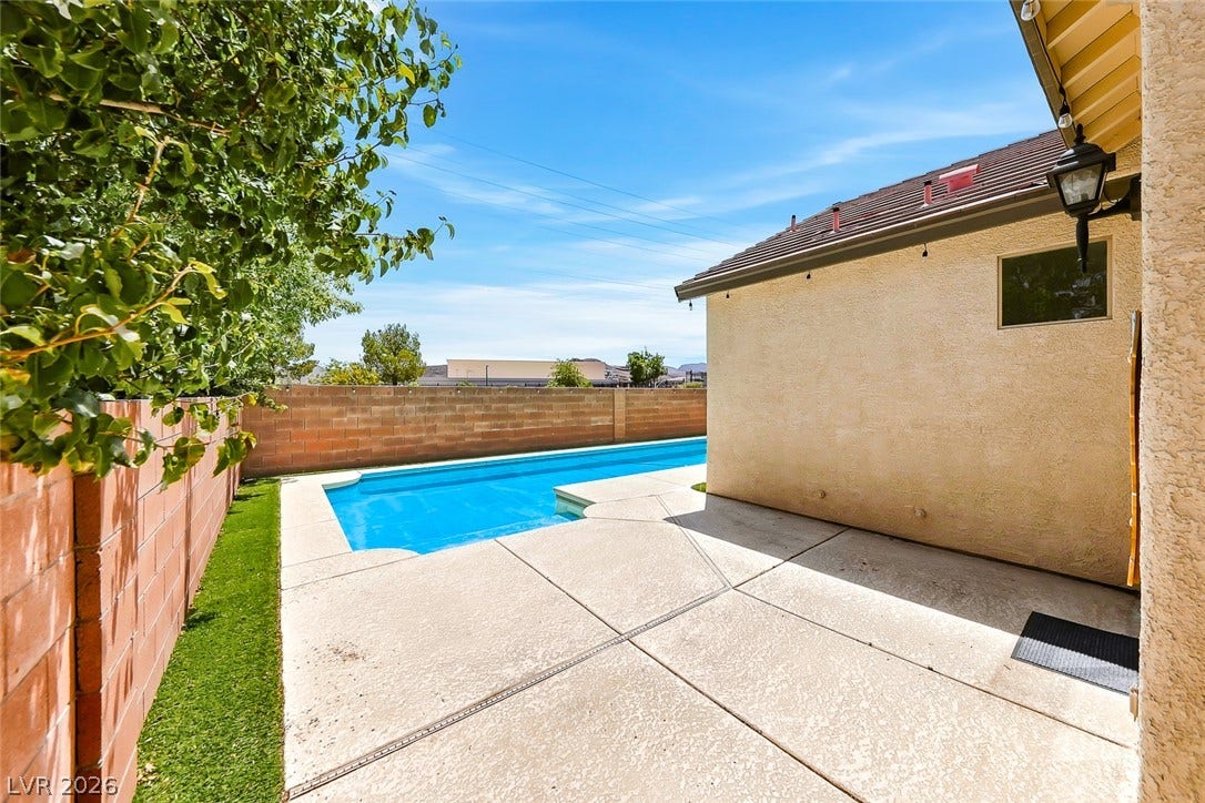 792 Valley Rise Drive, Henderson, NV 89052 A sparkling swimming pool highlights this backyard oasis, framed by concrete decking and brick fencing.