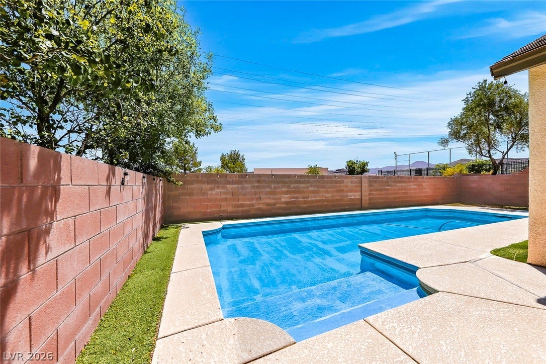 792 Valley Rise Drive, Henderson, NV 89052 A private swimming pool is enclosed by privacy block walls under blue skies.