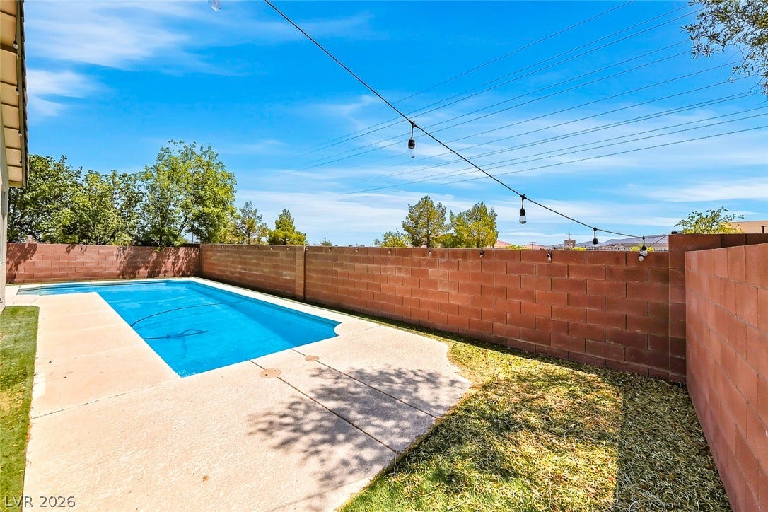 792 Valley Rise Drive, Henderson, NV 89052 An inviting swimming pool is enclosed by a privacy wall under wide open skies.