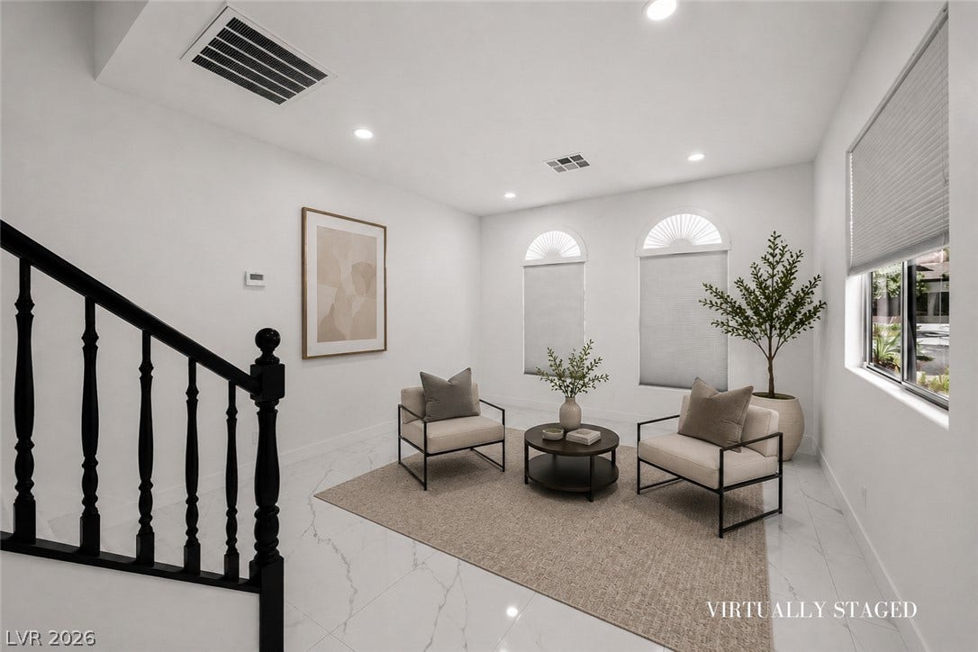 792 Valley Rise Drive, Henderson, NV 89052 Polished tile flooring and recessed lighting define this inviting entryway sitting area near the stairs.