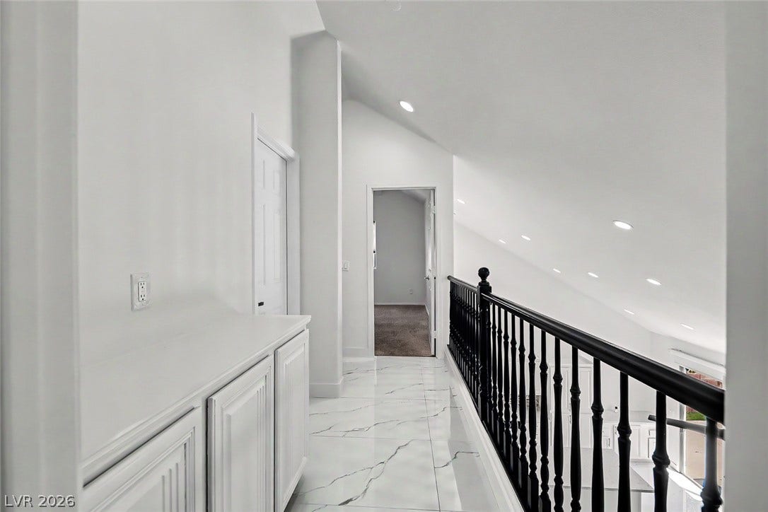 792 Valley Rise Drive, Henderson, NV 89052 Gleaming tile floors and vaulted ceilings define this airy upper-level landing with built-in cabinetry.