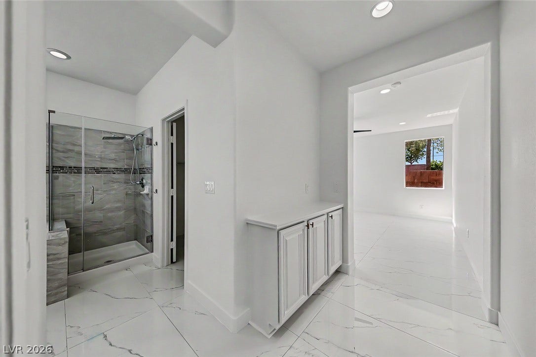 792 Valley Rise Drive, Henderson, NV 89052 Gleaming tile floors and clean architectural lines define this modern, light-filled bathroom entryway.