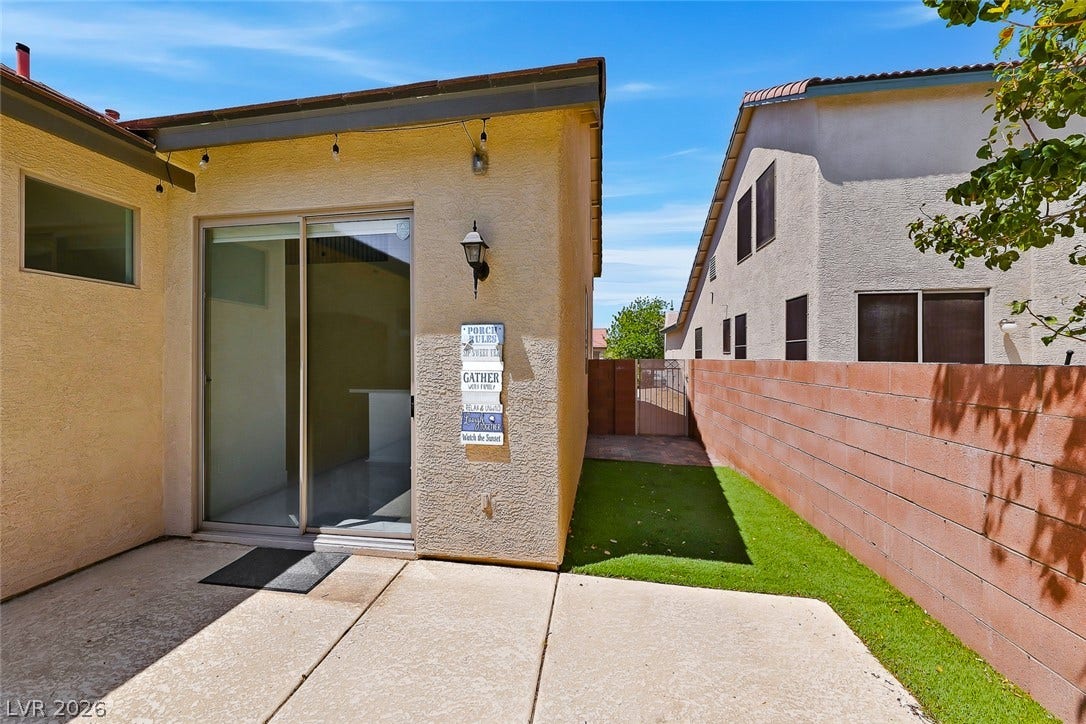 792 Valley Rise Drive, Henderson, NV 89052 Concrete patio details open to a private yard enclosed by masonry fencing.