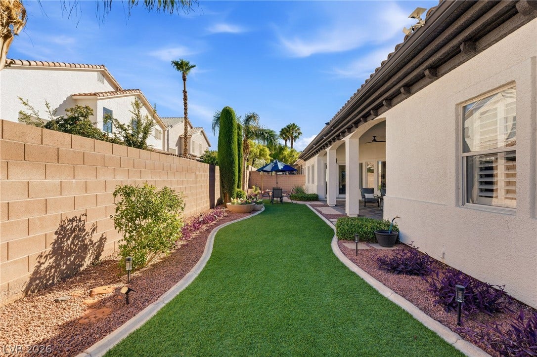 210 Torrey Morgan Way, Henderson, NV 89074 Lush turf grass and neat desert landscaping line this sunny, walled backyard retreat.