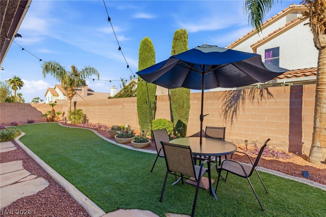 210 Torrey Morgan Way, Henderson, NV 89074 Manicured lawns and stone pathways define this tranquil, walled backyard oasis.