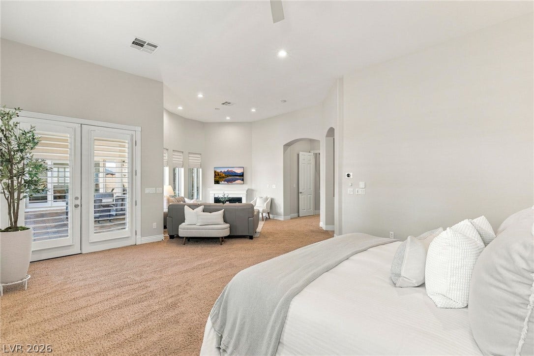 210 Torrey Morgan Way, Henderson, NV 89074 An open doorway and patio doors connect this bedroom suite to the main living area.